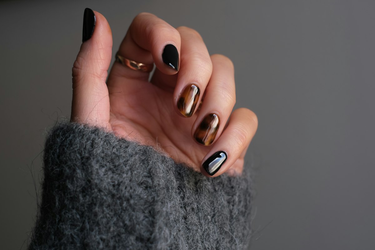 Glossy black gel manicure with silver ring