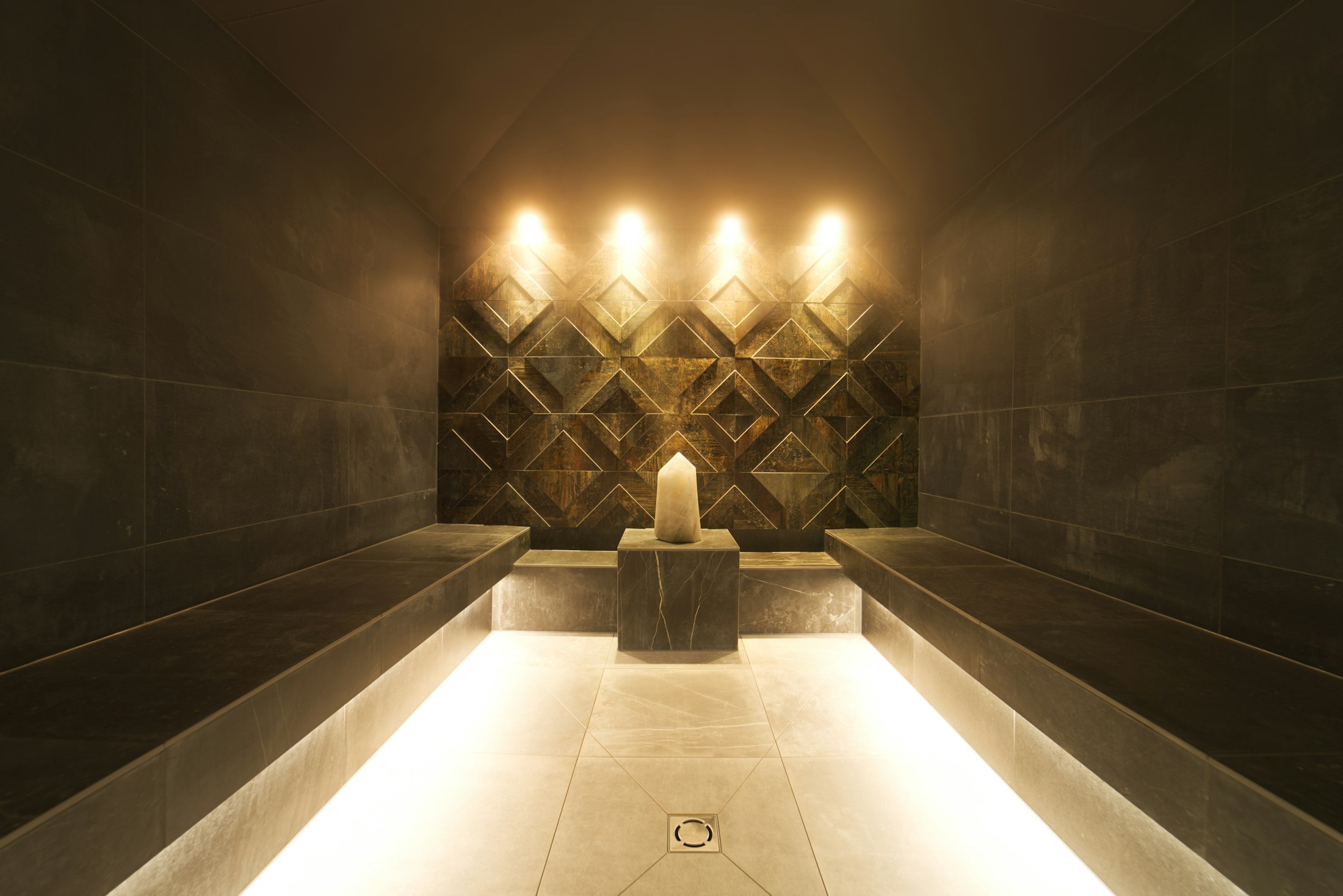 Candle-lit spa room glowing in warm golden light